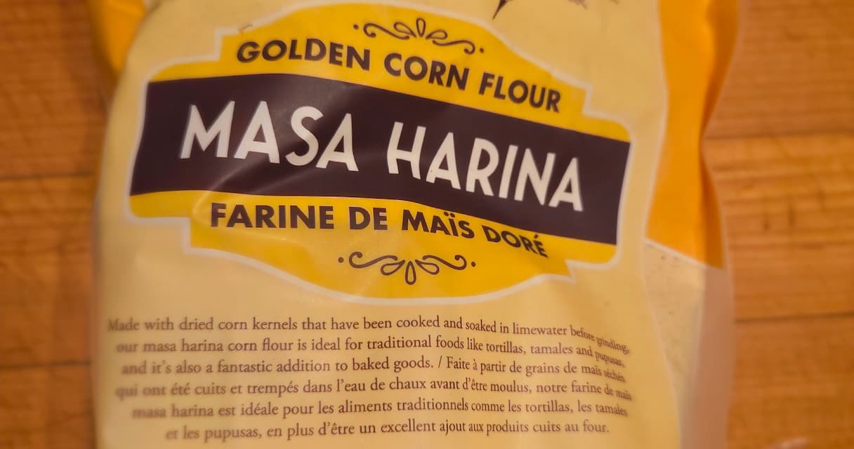 Bag of Maseca corn flour beside a bowl of masa dough and freshly pressed tortillas